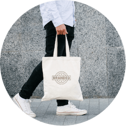 Woman Holding White Tote Bag with Branded Logo