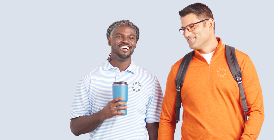 Two men wearing branded polos and zip-up shirts. options from the custom men’s apparel collection