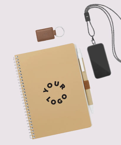 Beige spiral notebook with Your Logo on the cover, paired with a white pen, brown keychain, and black smartphone with lanyard,
representing custom merchandise for events & tradeshows.​