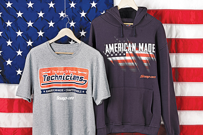 Tee and hoodie on hangers in front of American flag