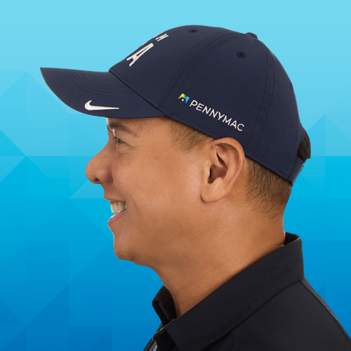 A side profile headshot of a man smiling while wearing a Team USA branded ball cap, highlighting the Nike and Pennymac logos