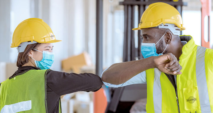 workers bumping elbows as an alternative to shaking hands